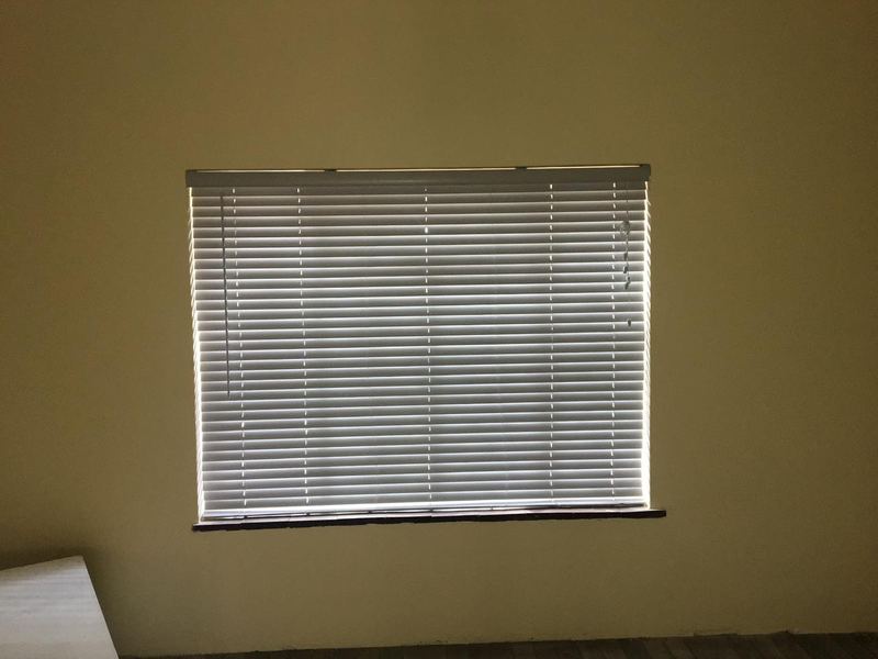 Aluminium venetian blind fitted square to a window