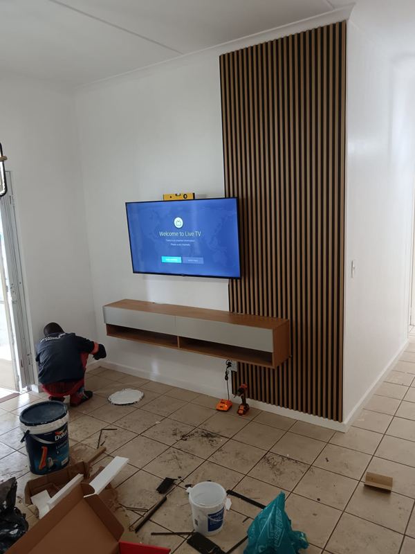 Slatted feature wall with a floating TV unit