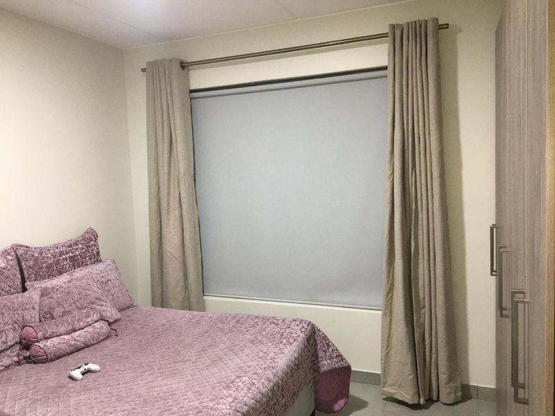 Roller blind and curtains in a main bedroom