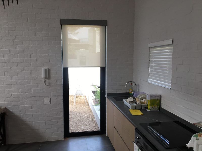 Roller blinds to a kitchen window and back door