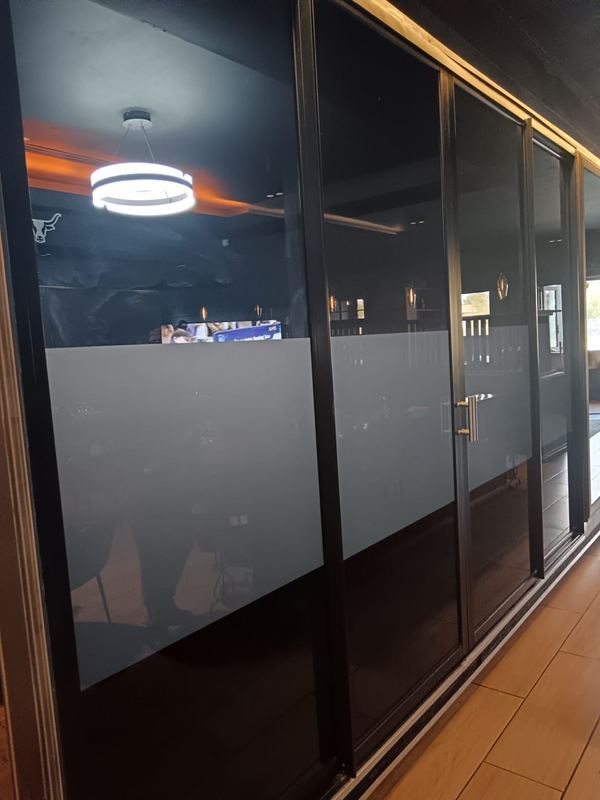 Frosted vinyl banding applied to a glass office partition