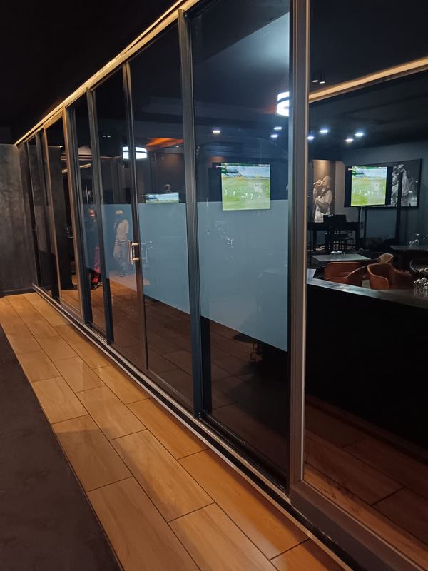 Frosted privacy banding along a glazed shopfront