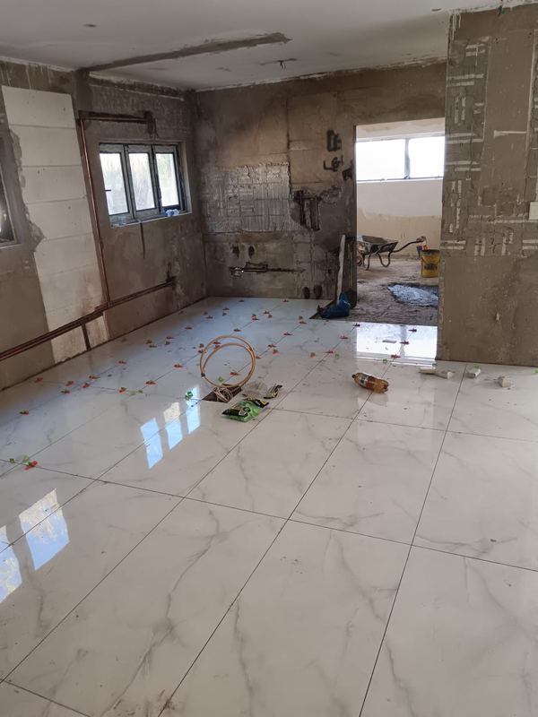 Marble-effect floor tiles laid across a living area
