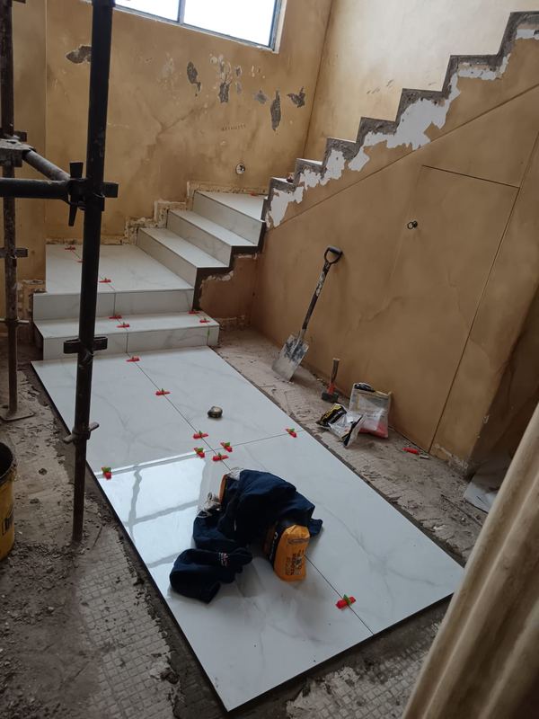 Staircase and landing tiled under scaffold