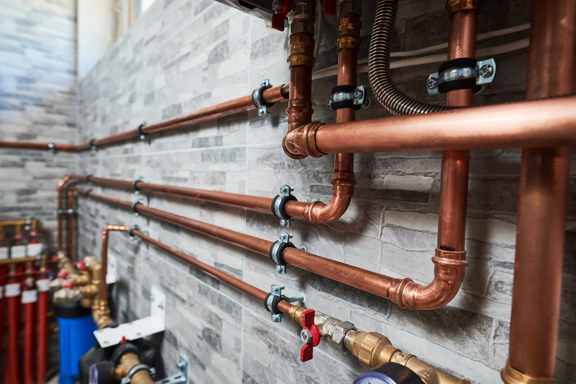 Copper pipework and valves installed on a plant-room wall