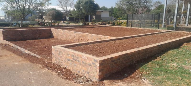 Face-brick raised planters built and backfilled with topsoil