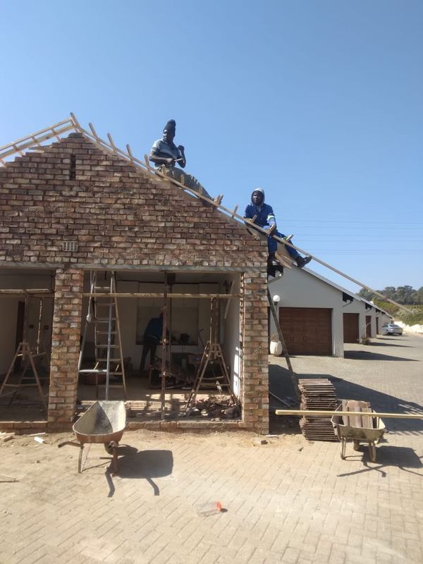 Battens fixed to a face-brick gable before tiling